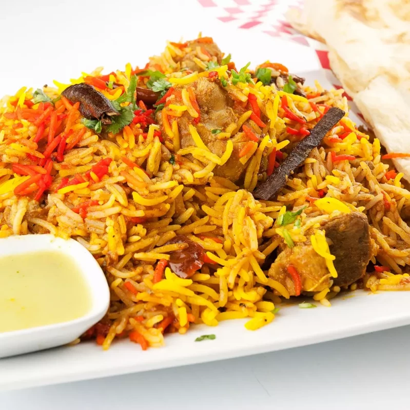 Chicken Dum Biryani at Indian BBQ & Grill Red Deer - Aromatic basmati rice layered with spiced chicken, slow-cooked to perfection